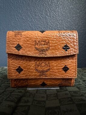 MCM Tan Logo Trifold Wallet with Black Monogram Accents